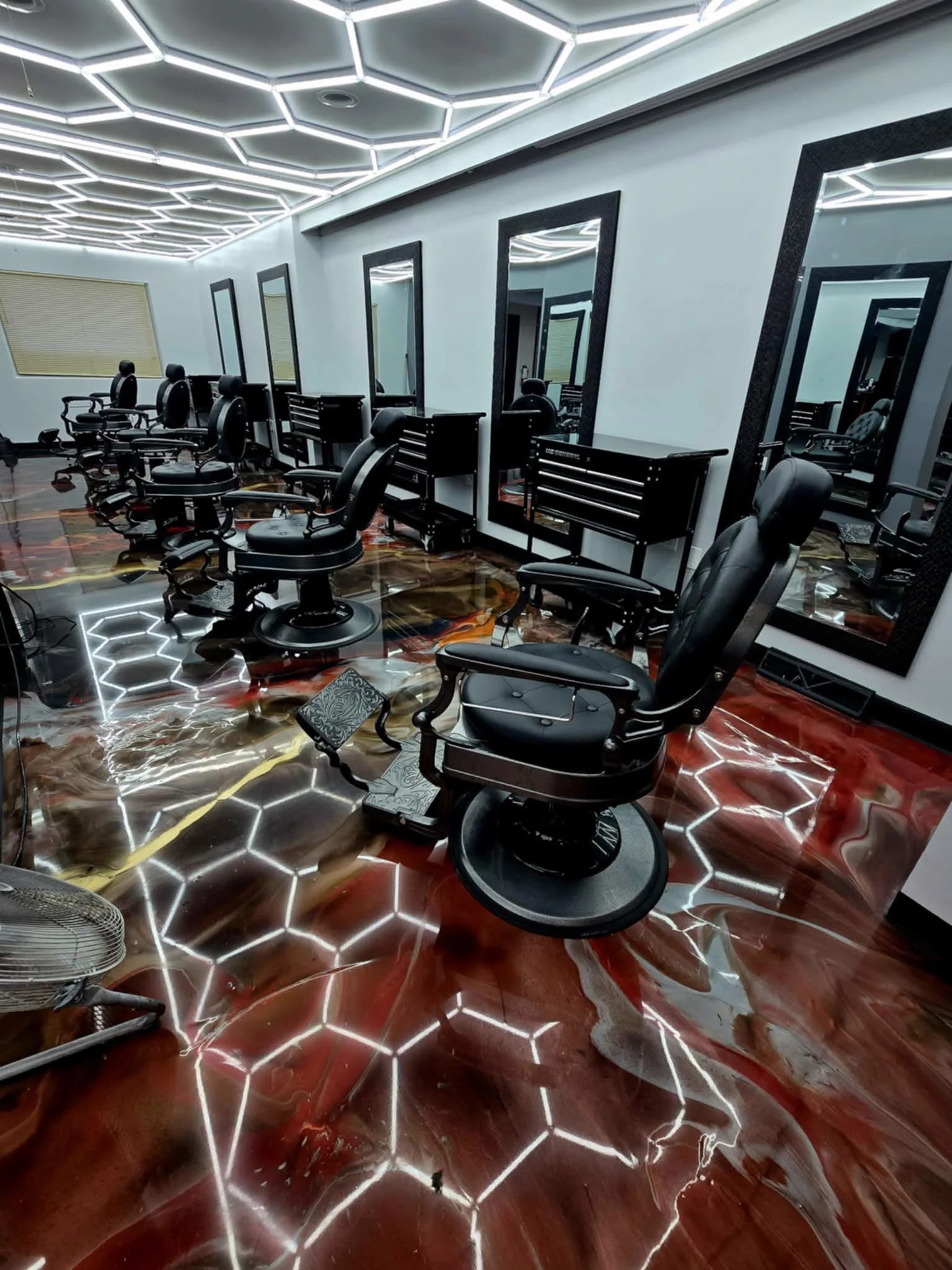 Barber chairs and hexagon ceiling lights inside Legends
